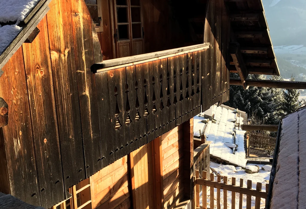 Holzchalet mit Schnee in österreichischer Berglage